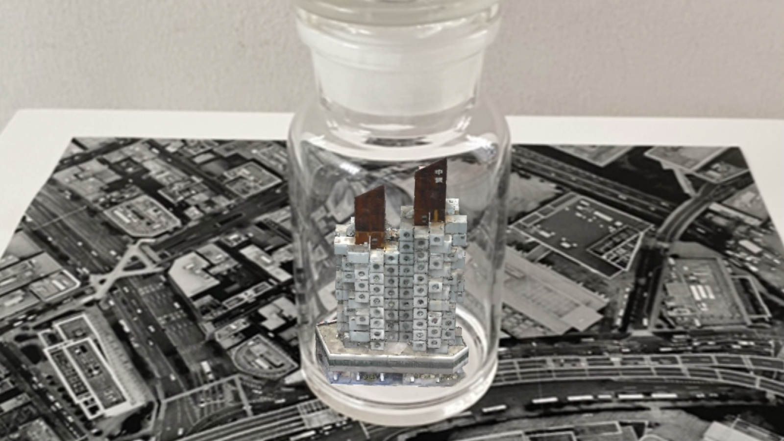 <em>Nakagin Capsule Tower in a Bottle</em>, 2024, bottle, photograph, AR