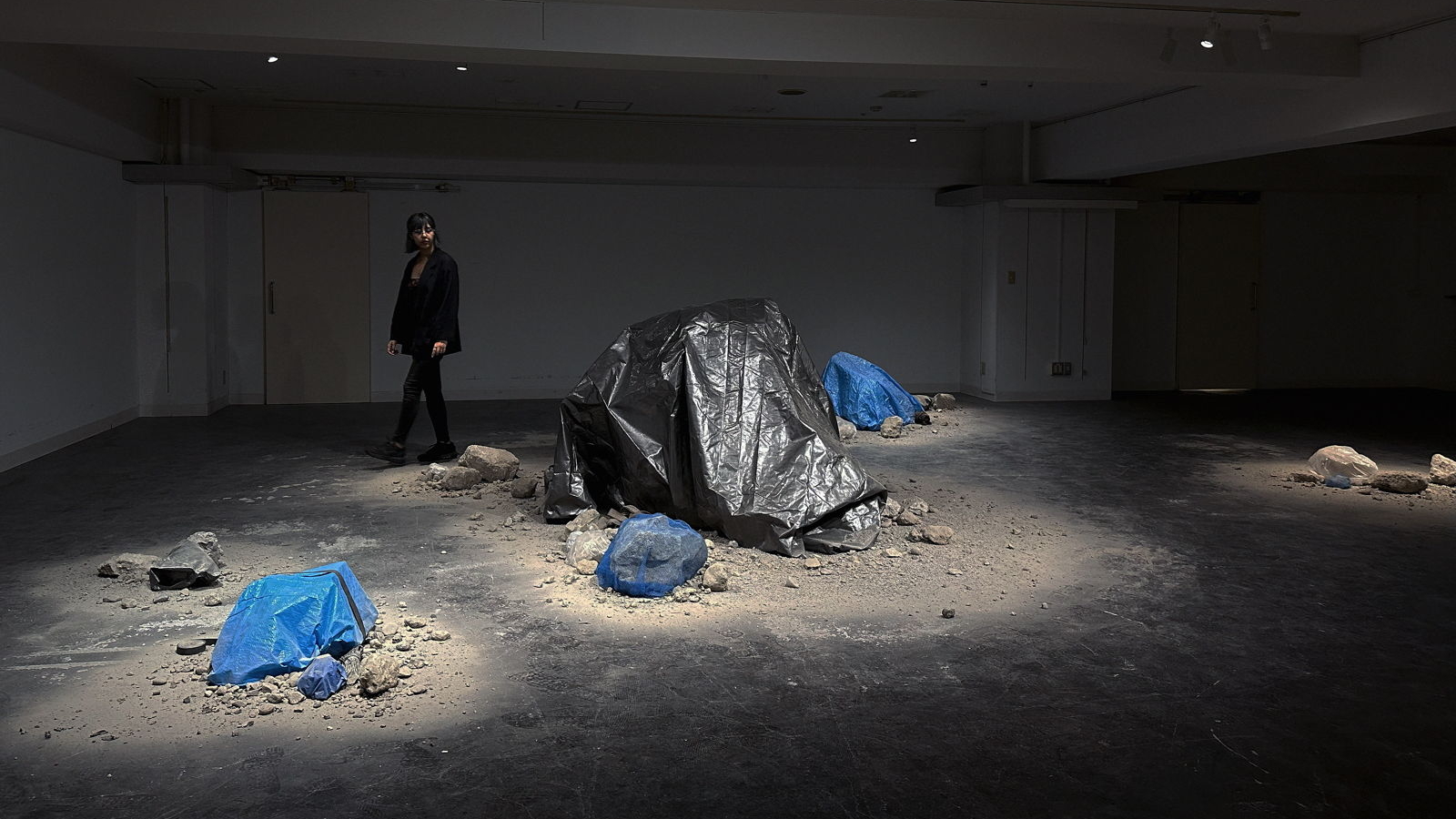 <em>Ghost Gardens</em>, 2023, installation with concrete rubble, tarpaulin, mixed material, tablets and sound.